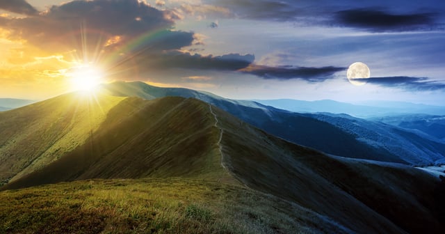 Photo of Sun and Moon over mountain range