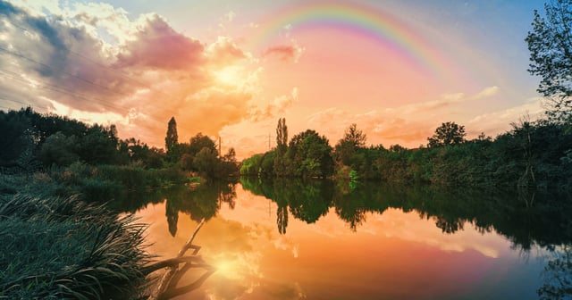 Golden hour sunset in nature with a rainbow