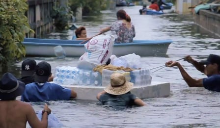 People floating their belongings down a waterway