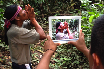 Achuar man recording another Achuar man with an iPad