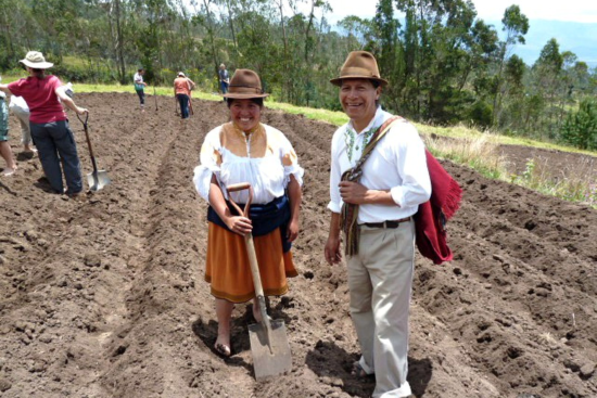 Indigenous man and woman using modern farming techniques 