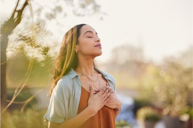 Woman with hands over her heart