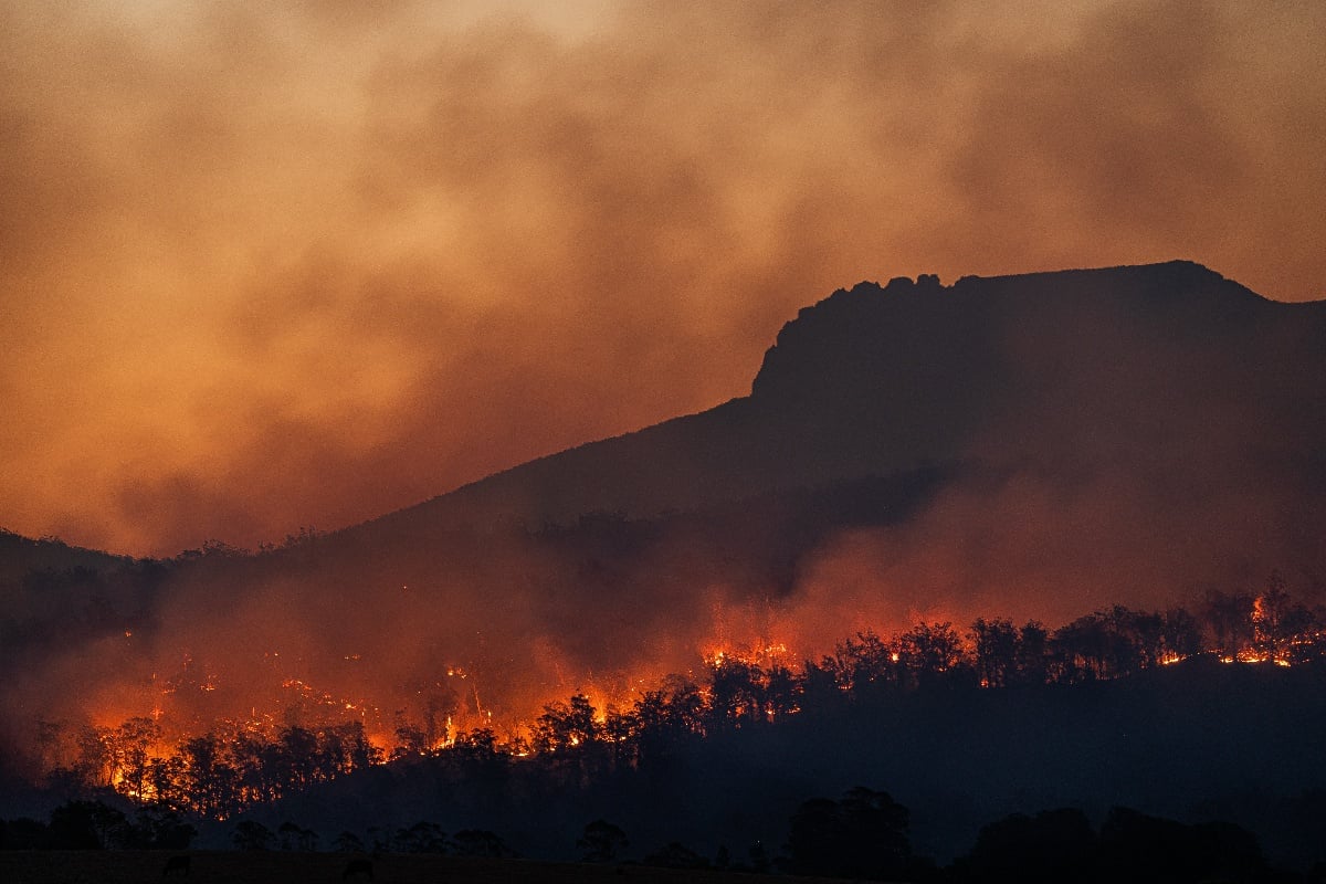 wildfire at the base of a mountain