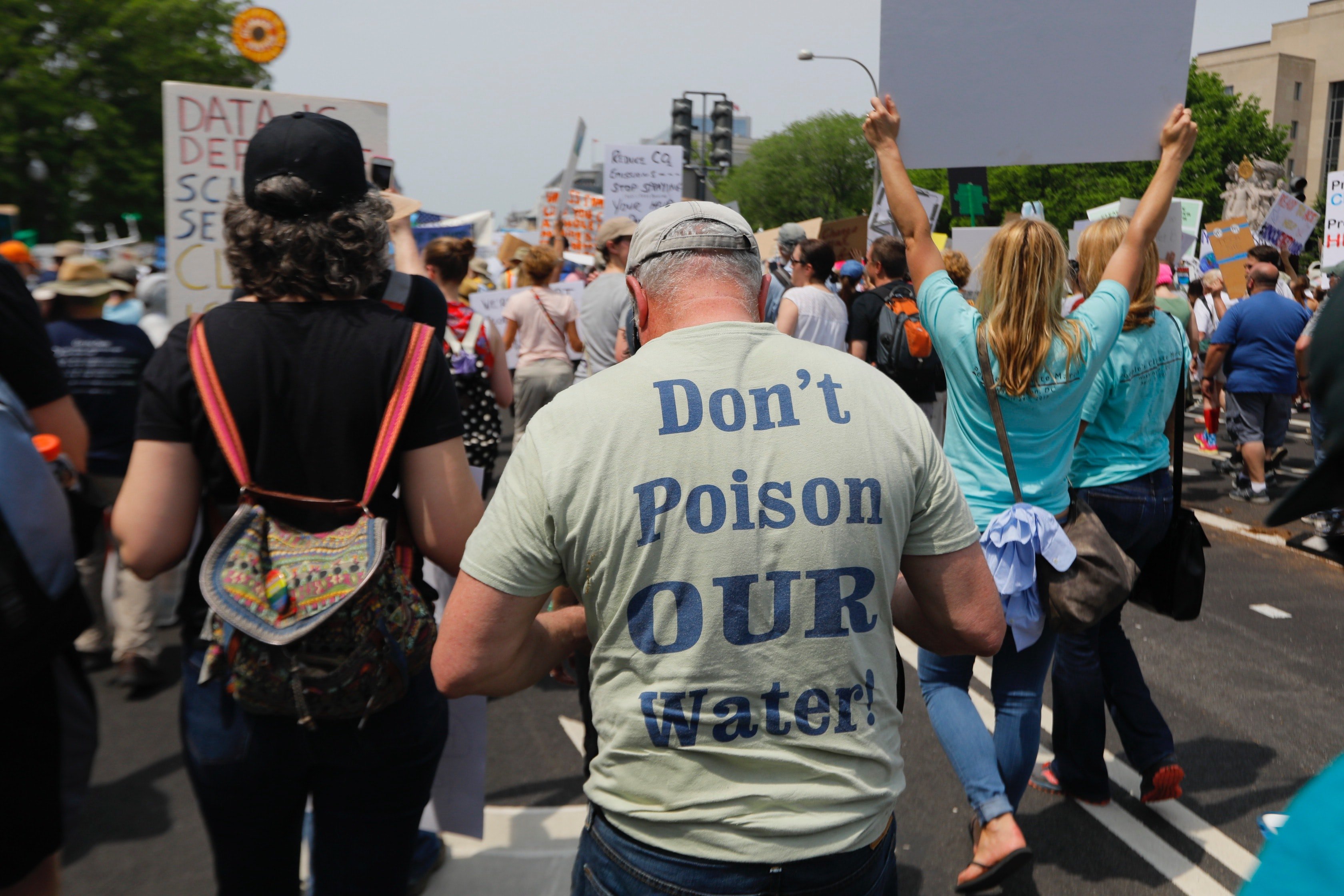 back of a protestor's shirt that says "don't poison our water!"